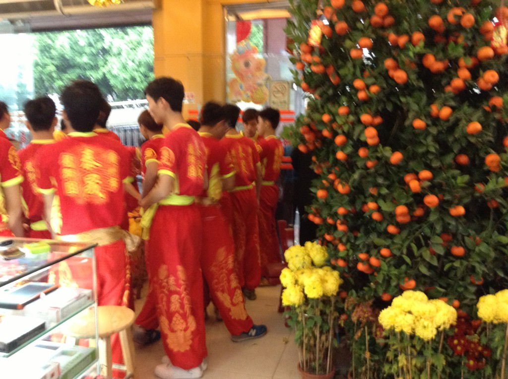 The boys standing in front of the main gate were preparing for the lion dance