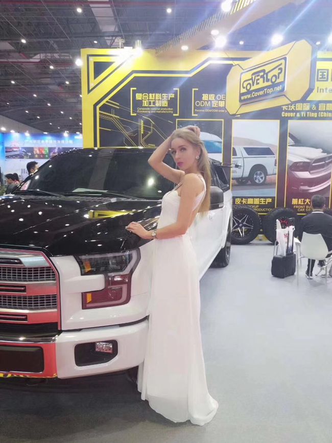 Models pose beside cars on display at Automechanika Shanghai 2017-1